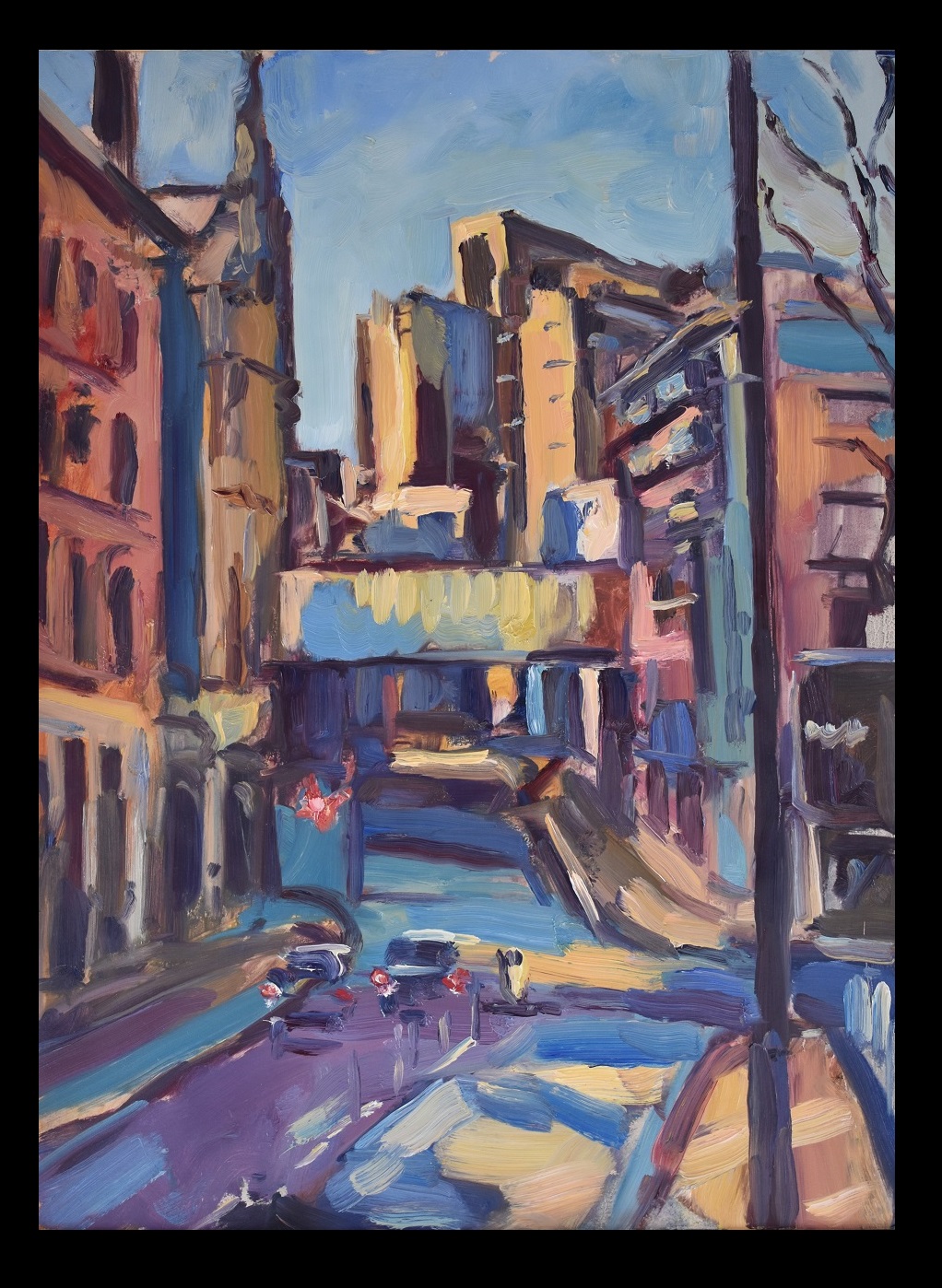 A view down a street under a bridge in Manchester
